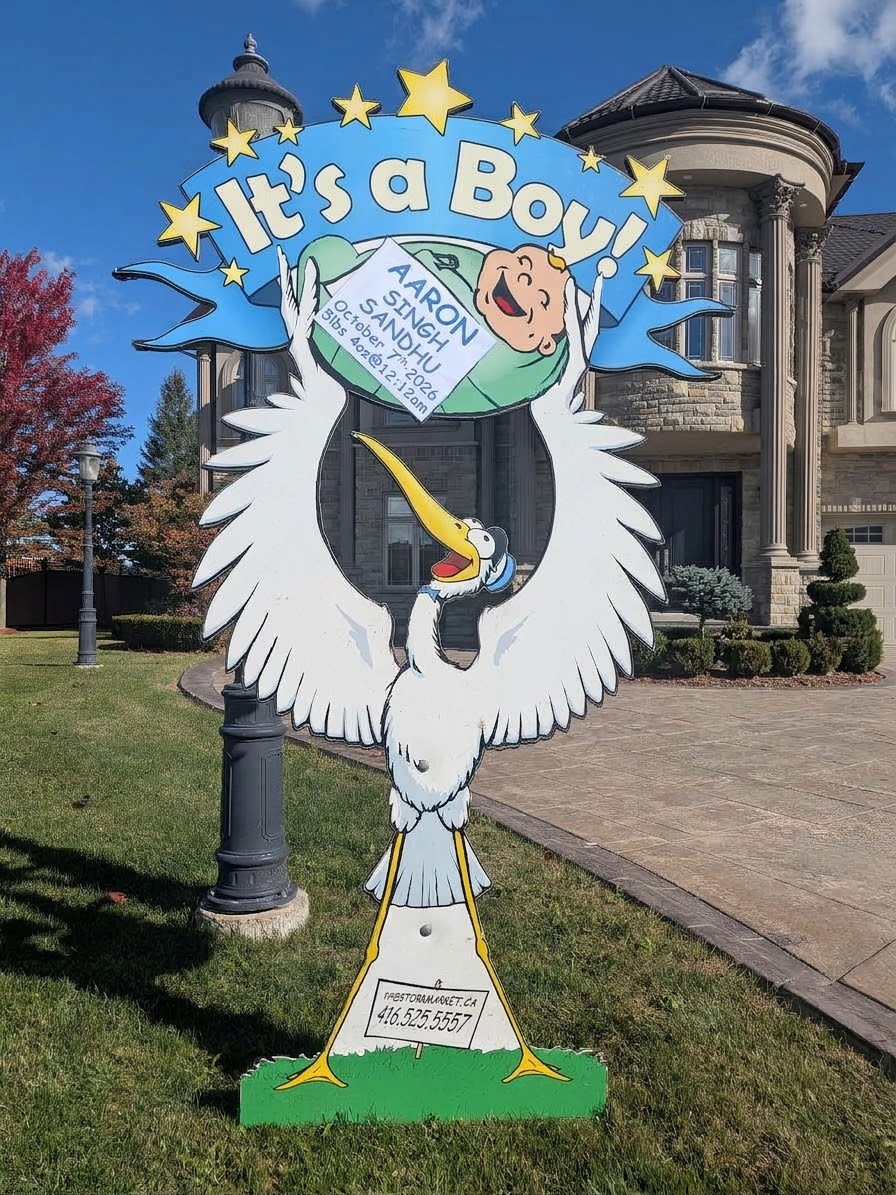Blue Aaron Singh Sandhu lawn stork sign on a front lawn — The Stork Market, serving Brampton and the GTA